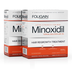 Two boxes of FOLIGAIN Men’s Minoxidil 5% Topical Solution.