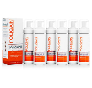 FOLIGAIN Men’s Minoxidil 5% Topical Foam cans arranged beside their box.