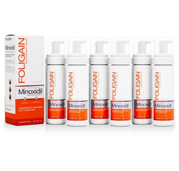 FOLIGAIN Men’s Minoxidil 5% Topical Foam cans arranged beside their box.