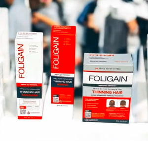 FOLIGAIN men’s TRIOXIDIL shampoo, conditioner and topical treatment in orange and white boxes.