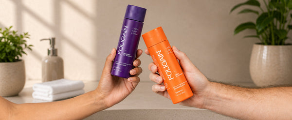 Hands holding FOLIGAIN men’s and women’s Triple Action Shampoo bottles.