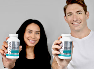 Woman and man holding FOLIGAIN Stimulating Supplement bottles